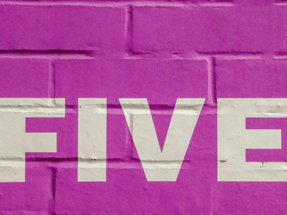 A purple wall with a white lettering "five"