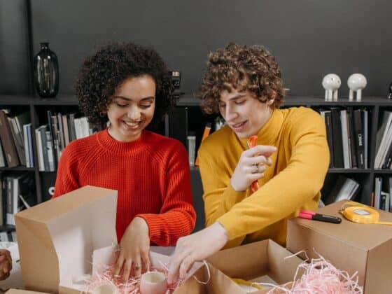 woman and man prepare a package with merchandise stuff