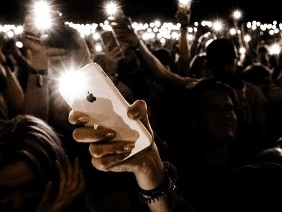 Crowd with smartphone flashlights