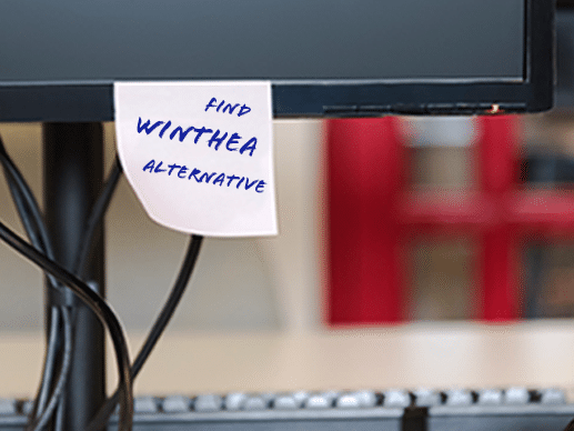 Monitor with sticky note saying "find WinTHEA alternative"